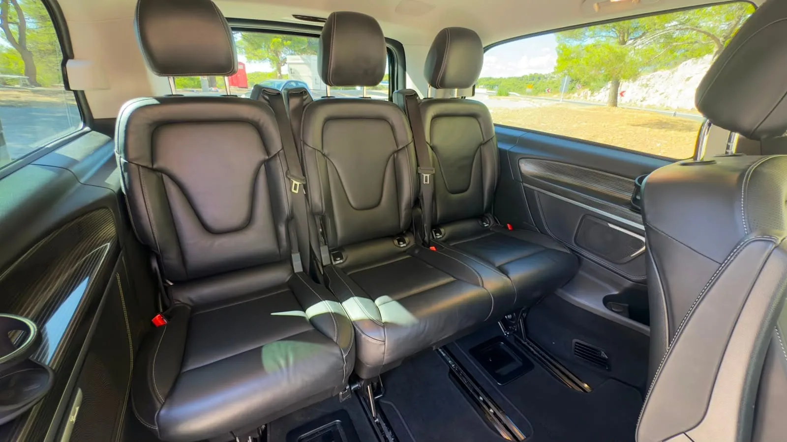 Row of three leather passenger seats in the back of the V-Class van