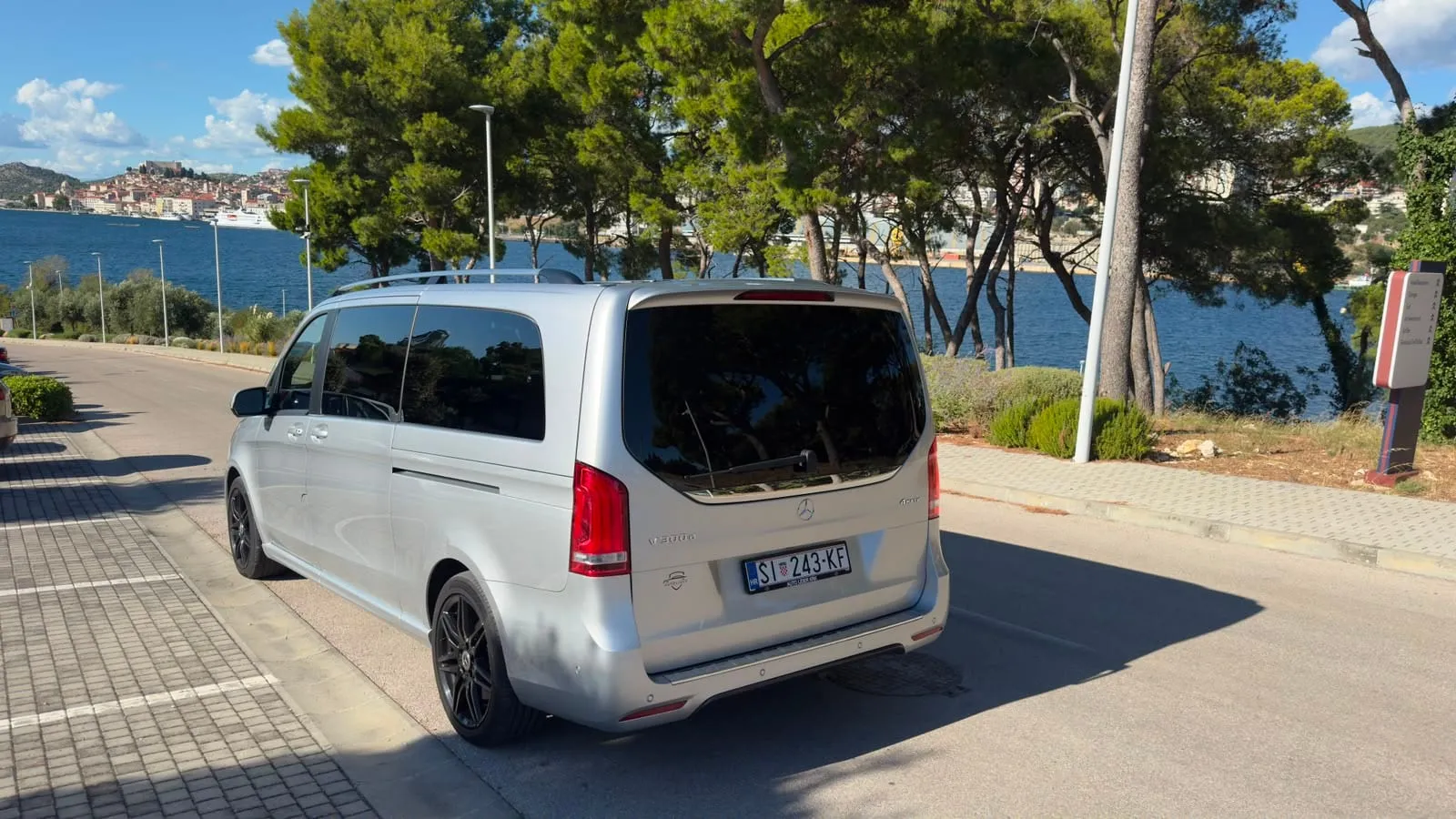 The Ardura Taxi van parked above the Šibenik channel, old town across the water